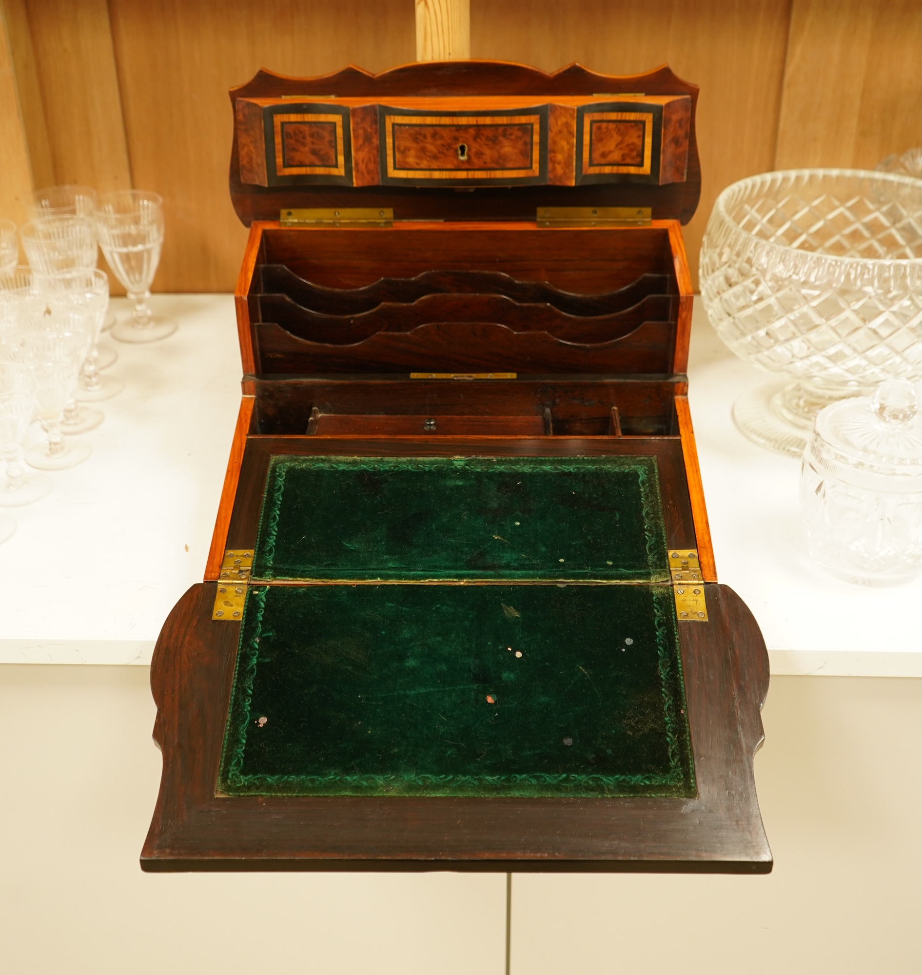 A 19th century French brass inlaid, tulip banded amboyna writing casket, the brass panel inscribed ‘Jane Lester’, 40cm wide